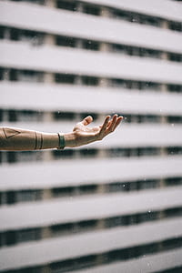 shallow focus photography of person's hand catching raindrops thumbnail