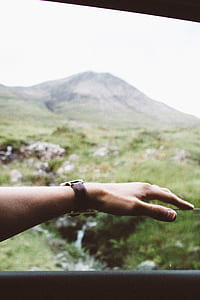 person wearing round gray watch thumbnail