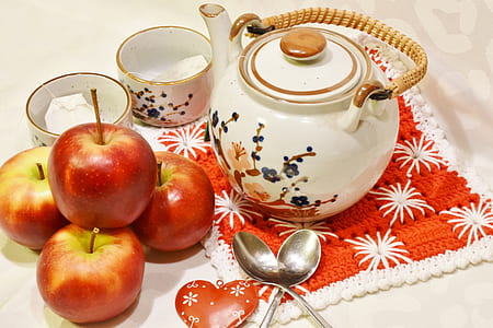 three honeycrisp apples beside white floral teapot and cups thumbnail