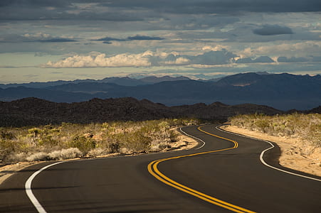 photo of asphalt road near desert thumbnail