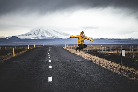 man jumping above empty road thumbnail