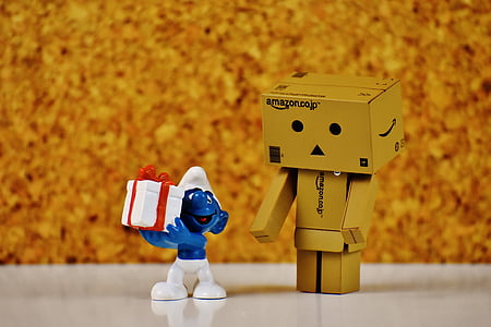 brown box man and Smurf character on white surface thumbnail