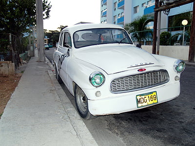 classic white coupe parked beside road thumbnail