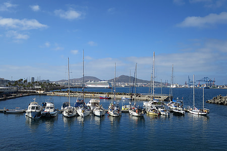 line of white boats on body of water thumbnail