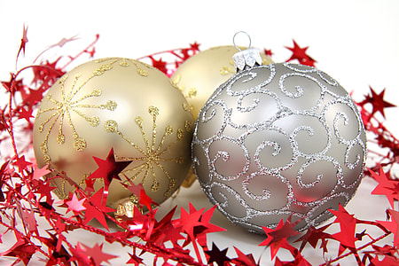 three gray and gold Christmas baubles on white surface thumbnail