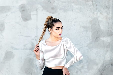 woman standing near gray wall thumbnail