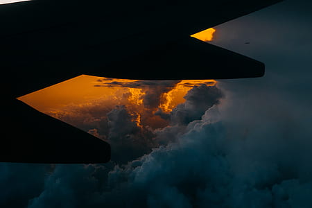 silhouette of airplane wing above the clouds thumbnail