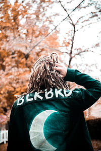 man holding his hair wearing black jacket thumbnail