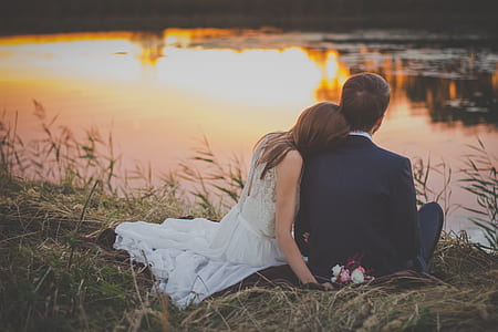 man and woman sitting on ground thumbnail