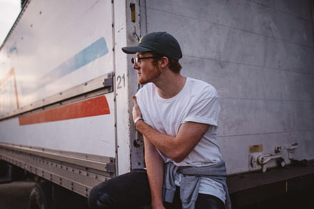 man wearing eyeglasses leaning on truck thumbnail