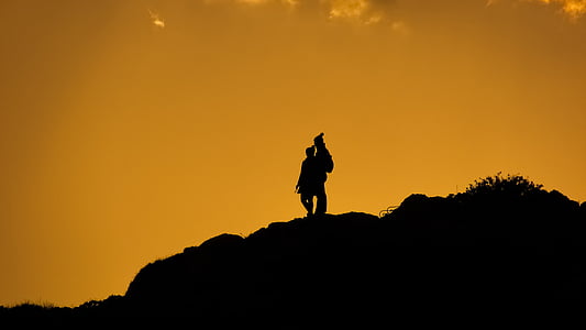 silhouette of man standing on mountain thumbnail