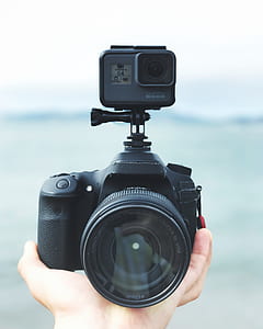 black DSLR camera with action camera thumbnail
