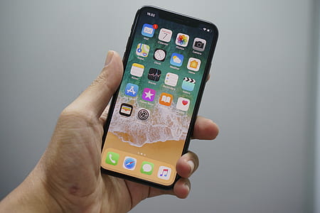 person holding space gray iPhone X thumbnail
