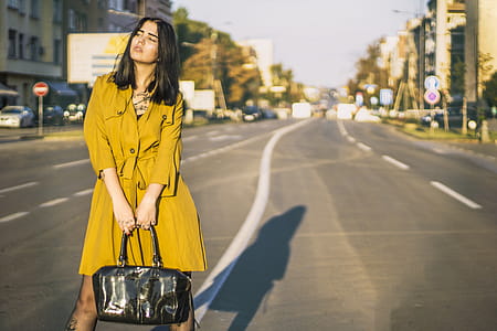 Woman Standing On Road Holding Leather Handbag thumbnail