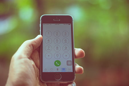 person holding space gray iPhone 5s thumbnail