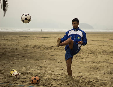 Man Playing Soccer on Beach thumbnail