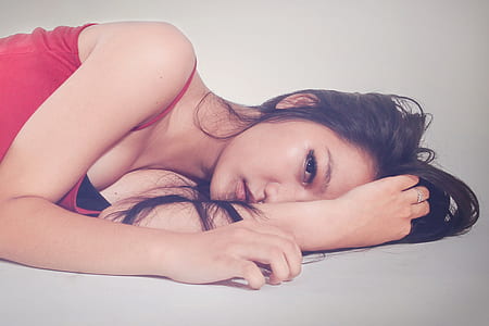 woman in red spaghetti strap top lying on floor thumbnail