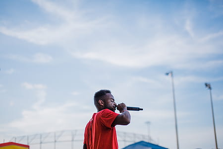 man using microphone under blue skies thumbnail
