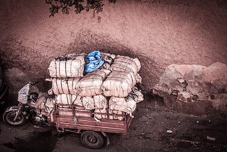 red and black auto rickshaw with white sacks thumbnail