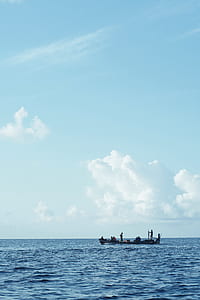 silhouette photography of group of people riding boat on body of water thumbnail