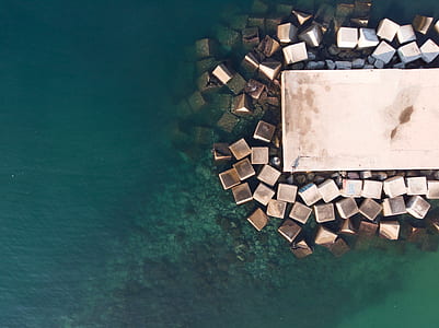 aerial photography of white concrete dock on body of water thumbnail