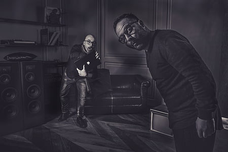greyscale photo of two man standing inside house thumbnail