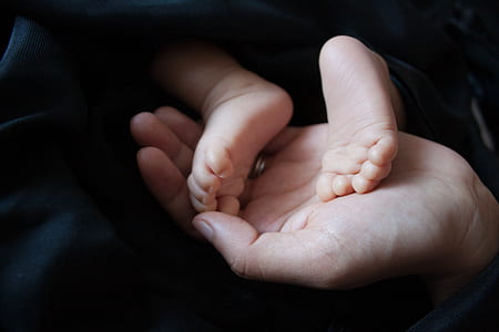 person holding baby's feet thumbnail