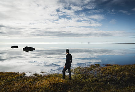 man standing on green grasses thumbnail