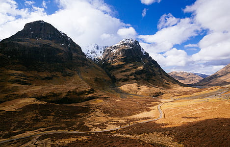 brown rocky mountain under white cloudy sky thumbnail