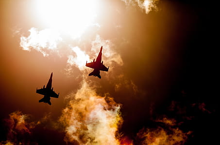 low angle photography of fighter jet silhouette thumbnail