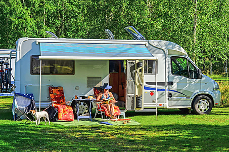 white RV van parked on grass thumbnail
