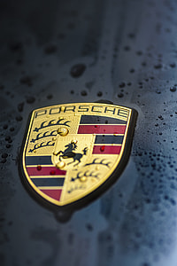 close-up photography of Porsche emblem with water droplets thumbnail