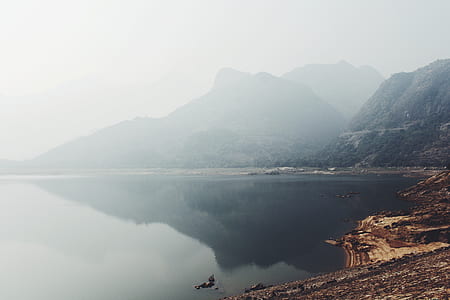 landscape photo of calm lake near mountain at daytime thumbnail