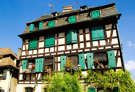 white, black, and gray house under blue sky thumbnail