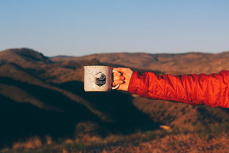 person holding coffee mug thumbnail