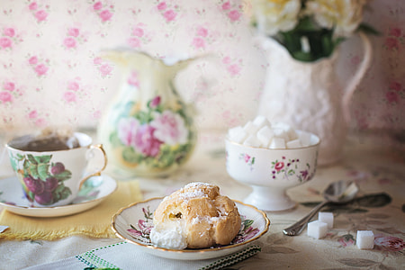 bread on floral saucer near tea set thumbnail