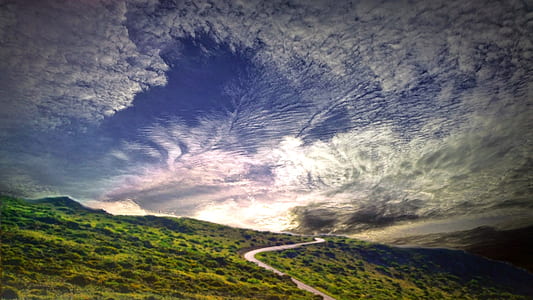 green mountain under cloudy sky during daytime thumbnail