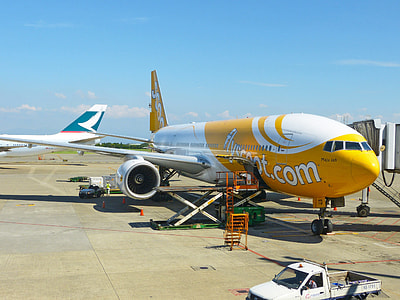 white and yellow airplane under blue sky during daytime thumbnail