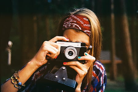 woman holding film camera thumbnail