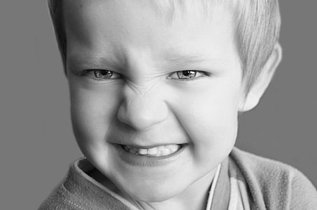 gray scale photo of boy with angry face thumbnail