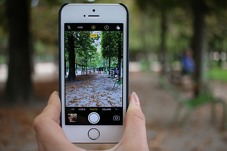 person holding iPhone taking photo of sidewalk during daytime thumbnail