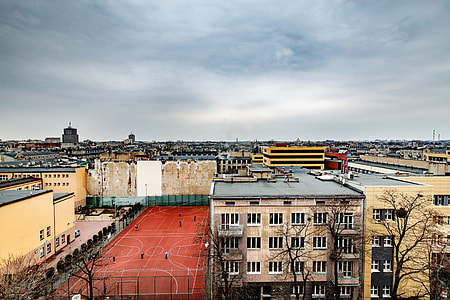red sports field near buildings thumbnail