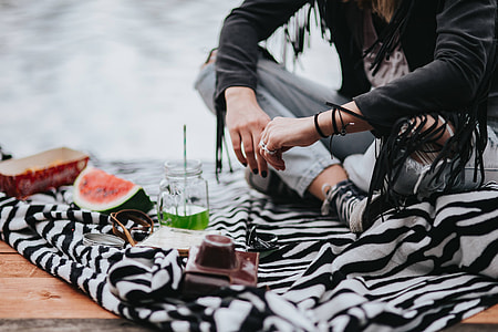 Blonde woman having a healthy snack at the wooden pier thumbnail