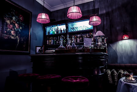 brown wooden mini bar station inside black painted room thumbnail