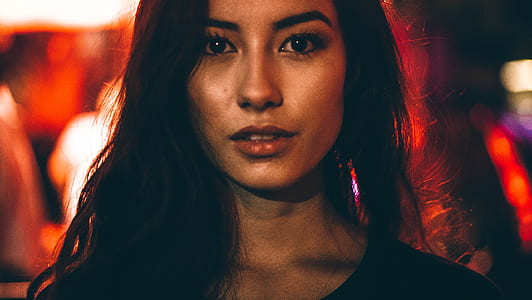 woman wearing black top near red lights thumbnail