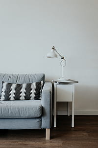 white desk lamp on white wooden end table thumbnail