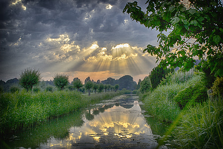 gray body of water in the middle of grassland thumbnail