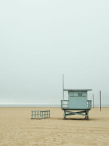 grey lifeguard shed on white seashore thumbnail