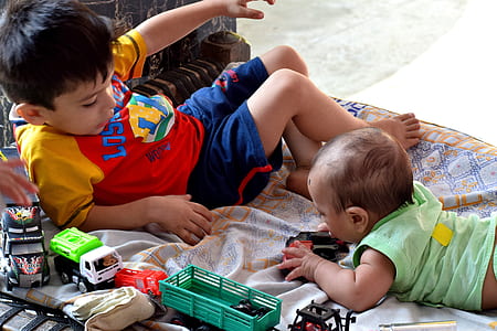 boy and baby playing on mat thumbnail