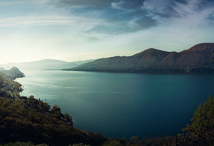 aerial view of body of water surrounded with mountains during daytime thumbnail